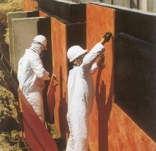 installation of a waterproofing membrane on the exterior wall of a basement