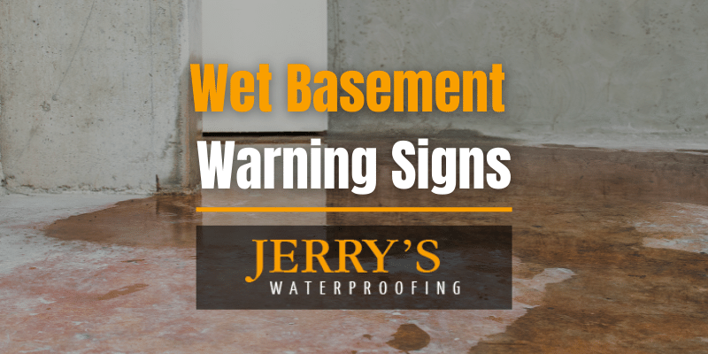 Wet basement floor with the words "Wet Basement Warning Signs"